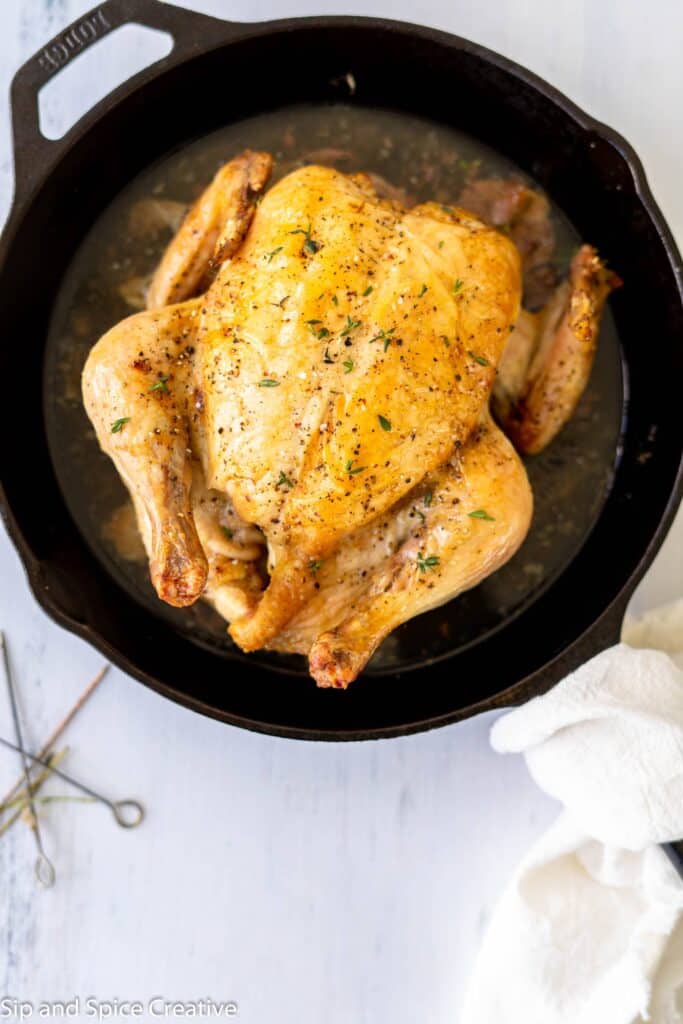 Roast chicken with thyme in a cast iron skillet