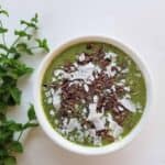 mint chocolate chip smoothie bowl with mint on side
