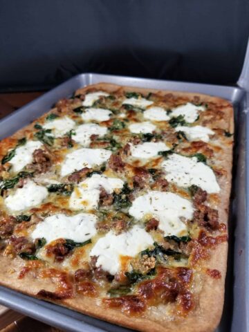 sausage spinach and ricotta pizza on whole wheat crust