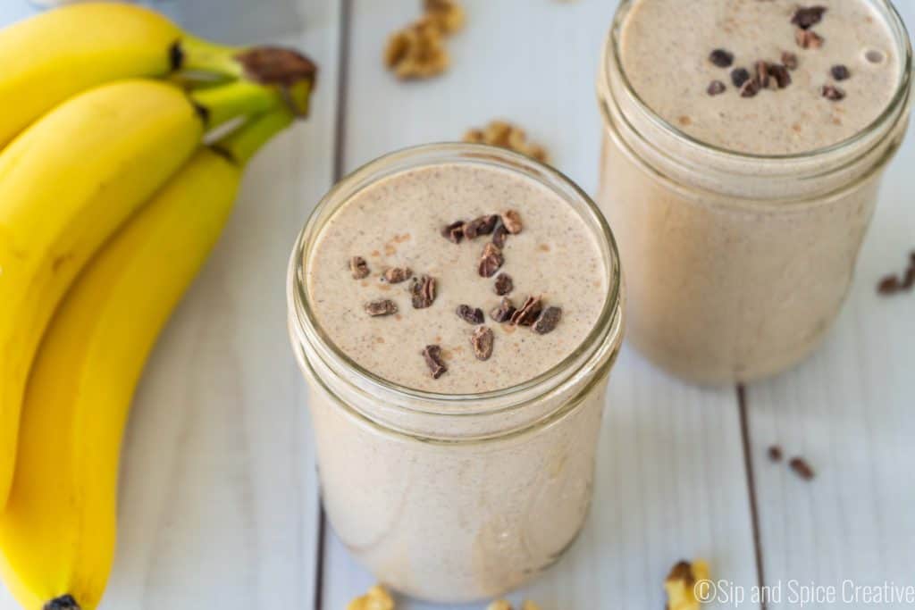 Chunky monkey smoothie topped with cacao nibs