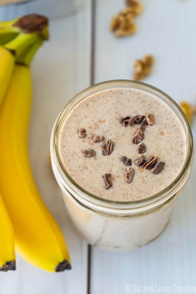 Chunky monkey smoothie with bananas and walnuts on the side