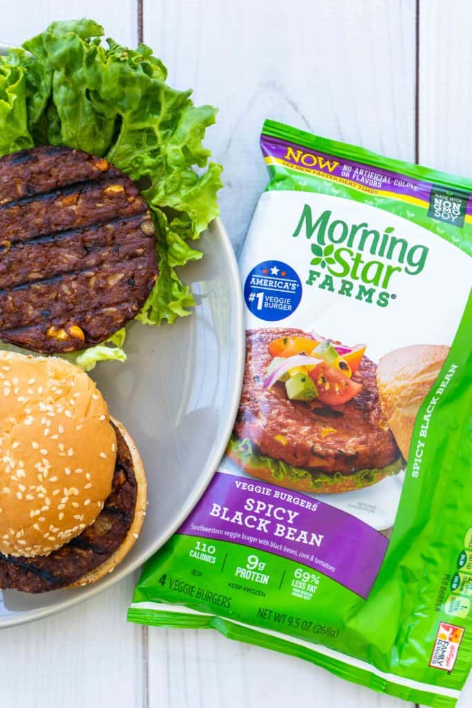 Morningstar Farms black bean burgers on a grey plate next to the packaging