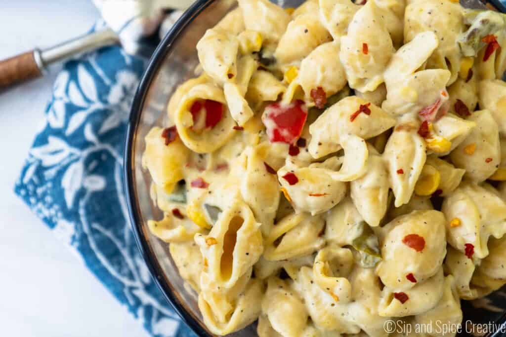 close up with vegan mac and cheese with roasted vegetables on blue napkin