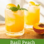 cocktail glass with basil sprig and peach slice
