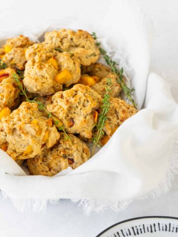 basket of peach scones with sprigs of thyme