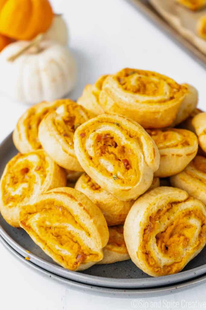a pile of pumpkin pinwheel slices on a grey plate