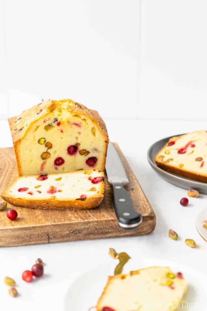 cranberry pistachio pound cake with a slice removed