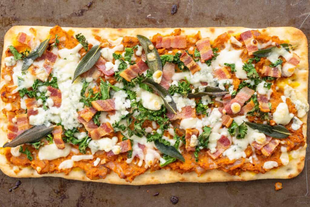 Savory Pumpkin Flatbread with Bacon, Sage and Blue Cheese on a sheet tray