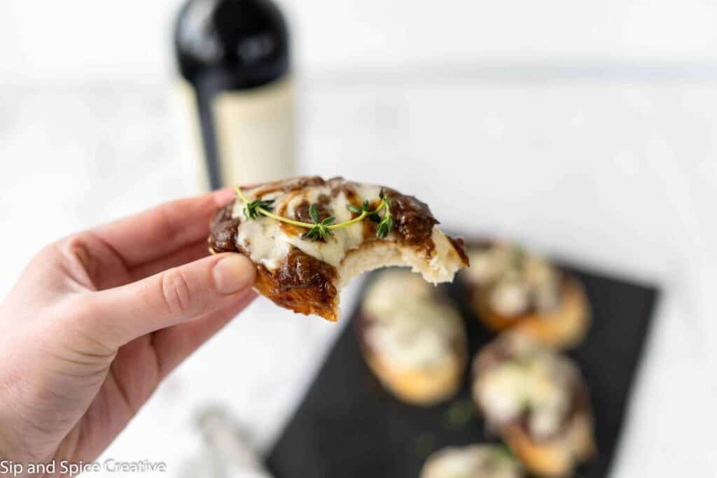 crostini in hand with bite taken out