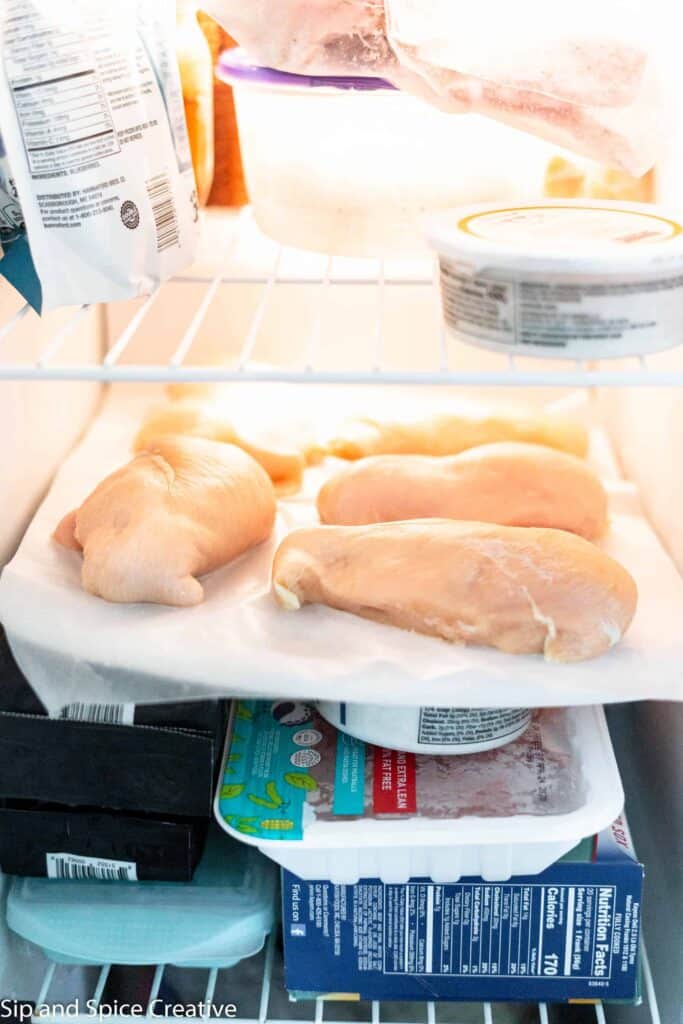 chicken breasts frozen in a stocked freezer