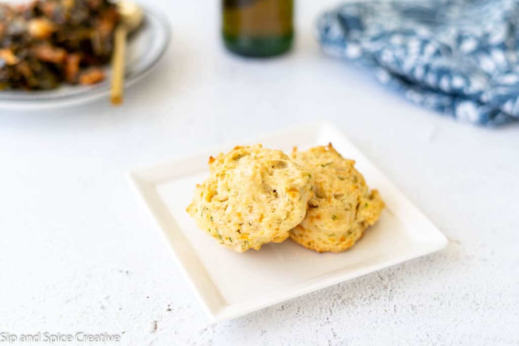 two biscuits on a white square plate
