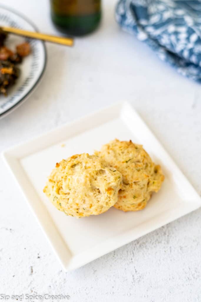 two dill biscuits on a white square plate