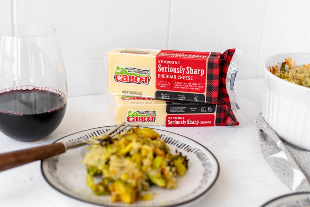 plate of winter vegetable gratin in foreground with focus on cabot cheese in background
